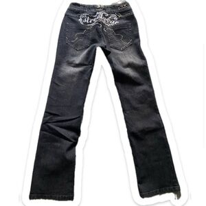 Low raison jean with embroidery tribal and affliction designs.